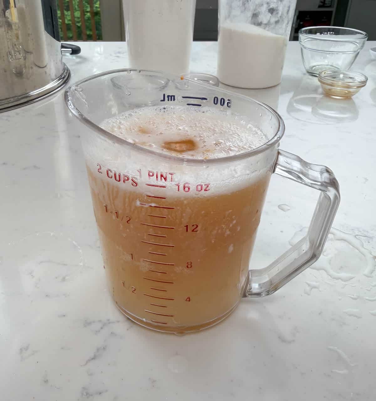 Pink champagne liquid ingredients in a measuring cup