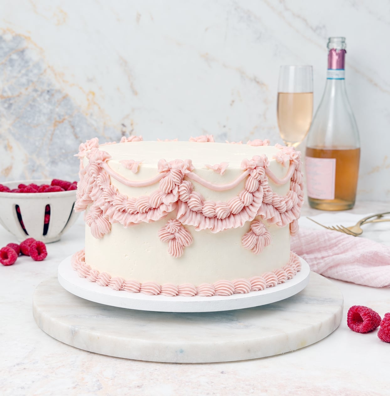 Pink champagne cake with white buttercream and light pink vintage piping