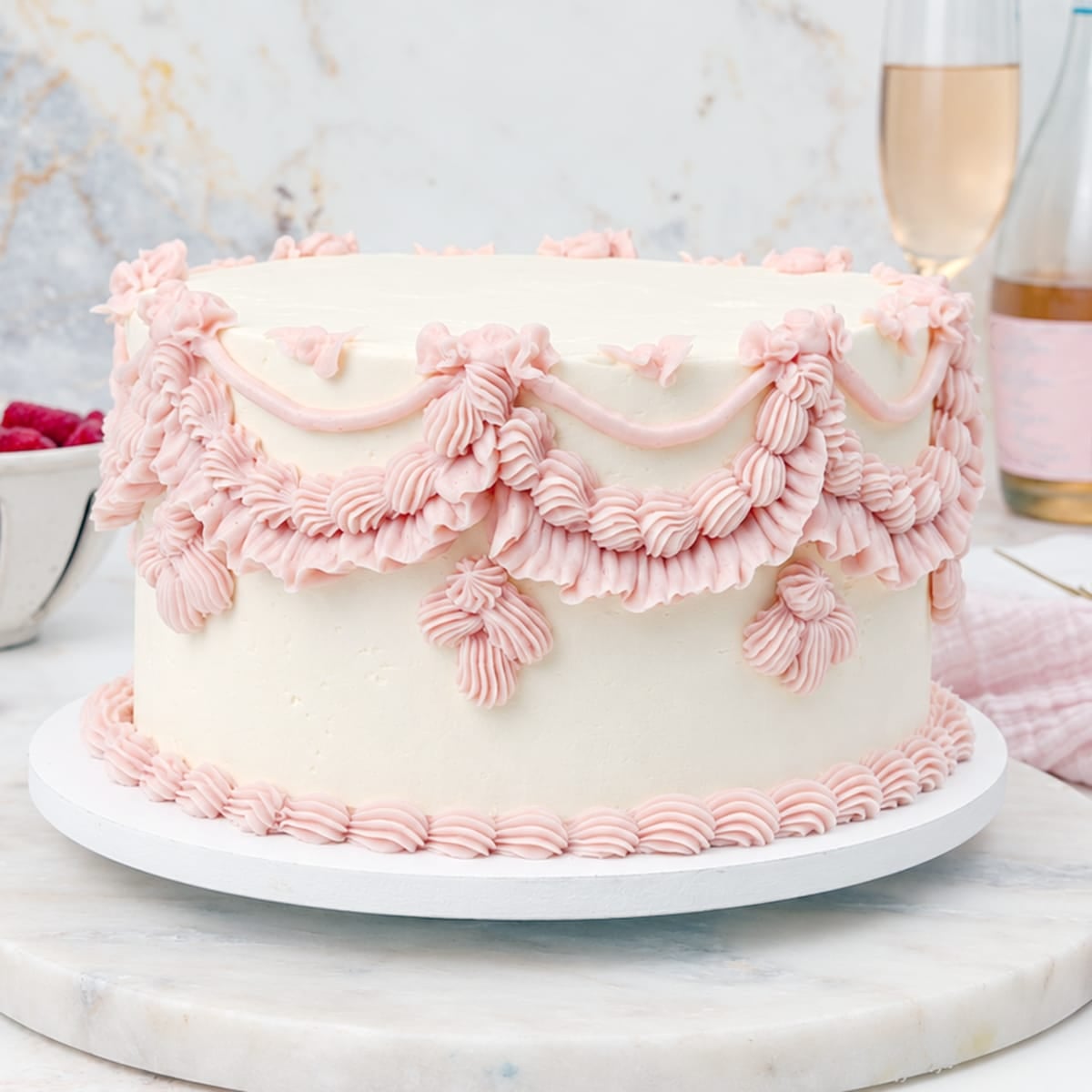 Close up of vintage piped pink champagne cake
