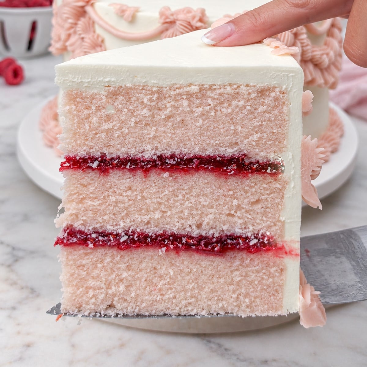 Close up of pink champagne cake with raspberry filling
