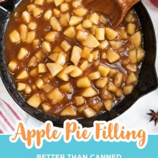 homemade apple pie filling in a cast iron skillet with a wooden spoon