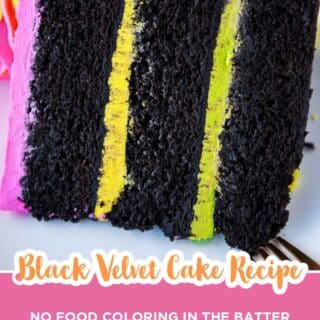 close-up of a slice of black velvet cake with bright pink and yellow buttercream