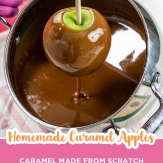 Green apple being lifted out of a pot of homemade caramel