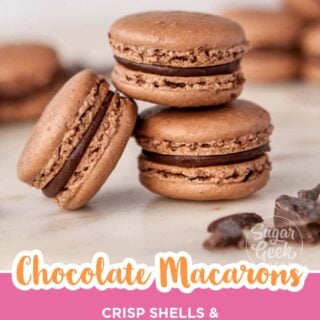 Chocolate macarons with chocolate ganache filling stacked on a marble counter, Pinterest image.