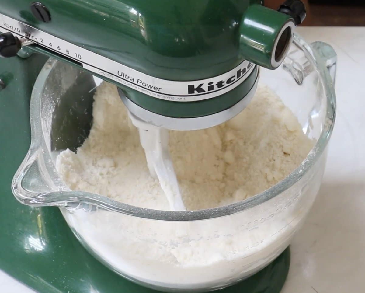 Flour and dry ingredients in a stand mixer bowl for chocolate mayonnaise cake.