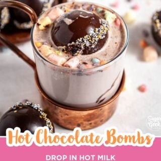 Hot chocolate bomb melting into a copper mug of hot cocoa with mini marshmallows.
