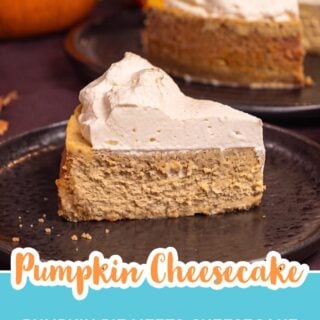 Slice of pumpkin cheesecake with whipped cream on a black plate with pumpkins and the whole cheesecake behind it