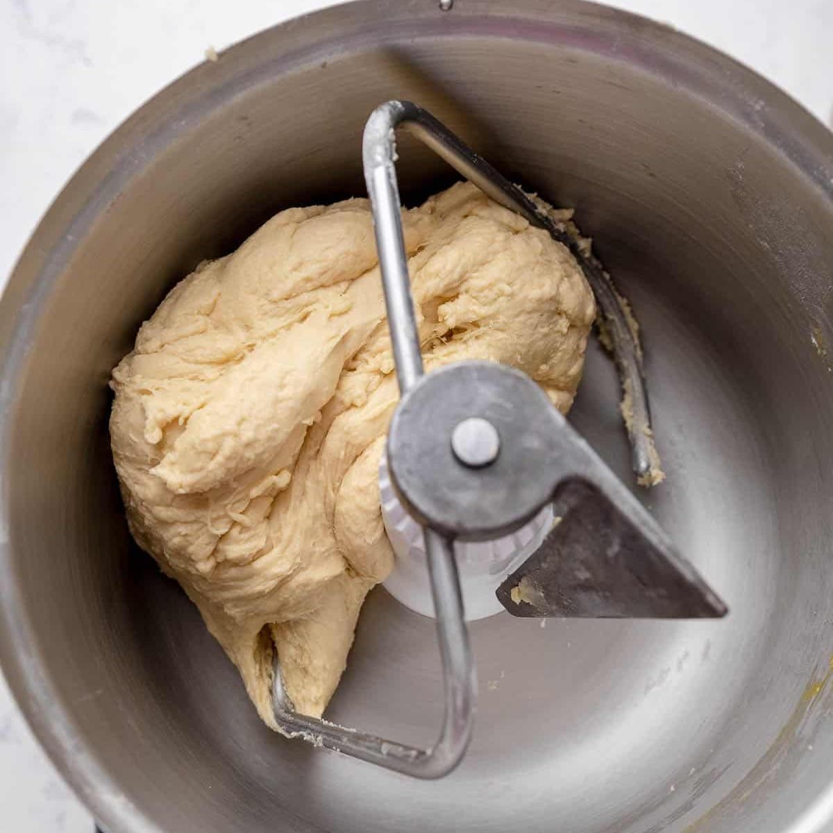 smooth soft sweet dough wrapped around a dough hook after 20 minutes of mixing